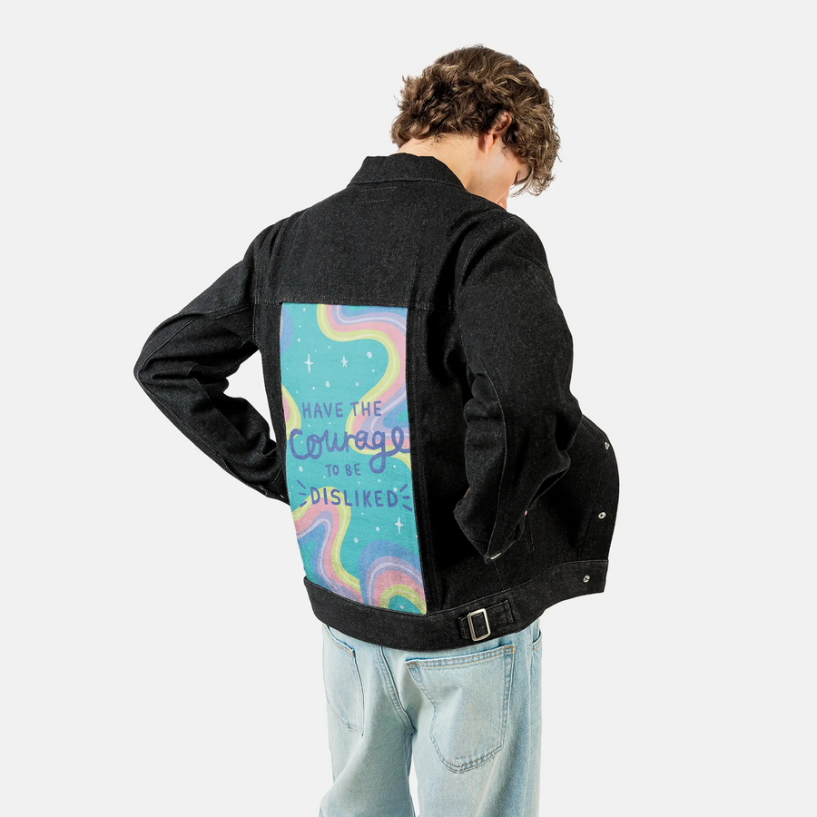 courage patch on male og denim jacket in raven