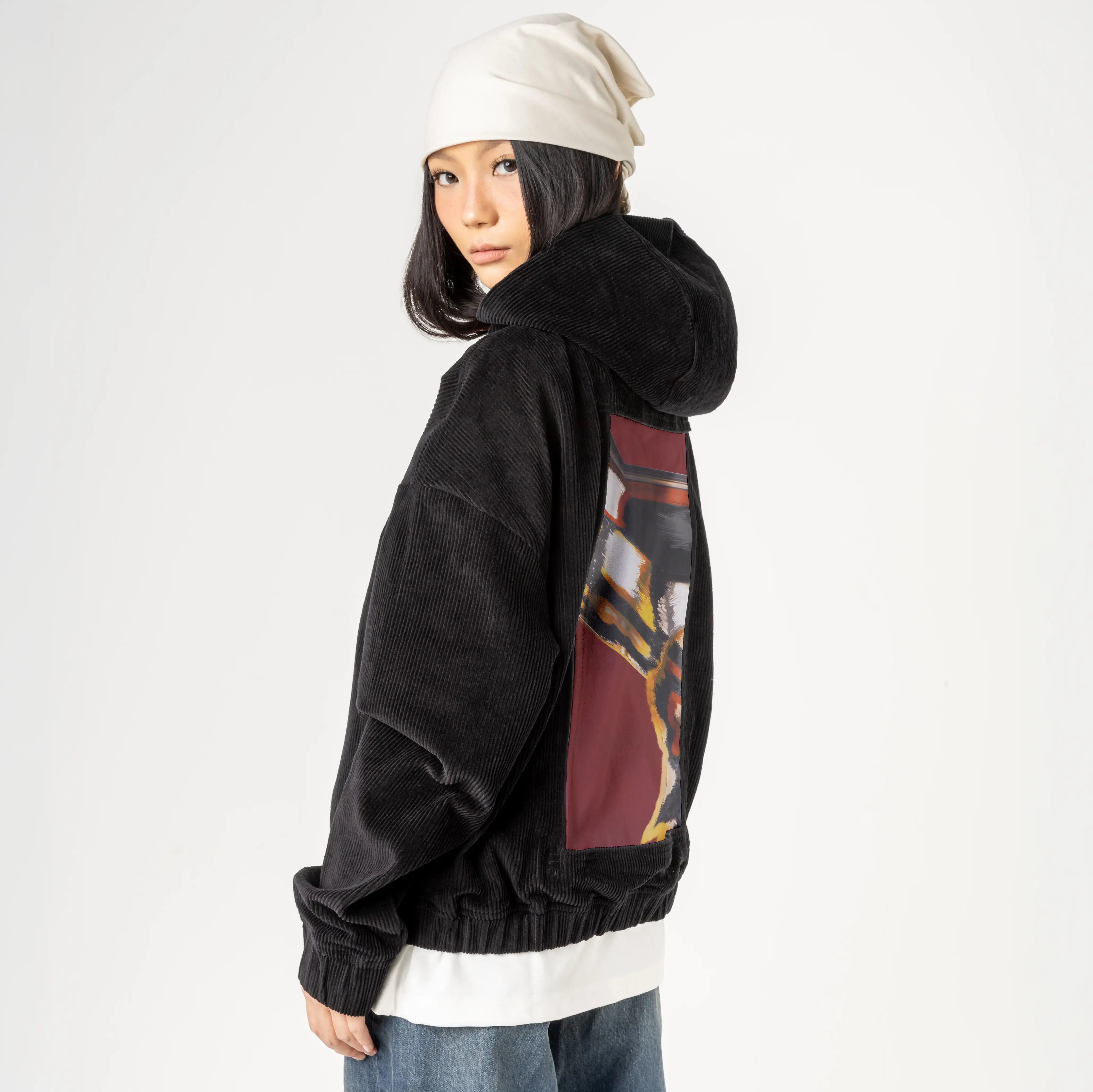 emberinmotion patch on female retro cord hoodie in onyx