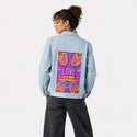 lovenevergivesup patch on female og denim jacket in oceanside