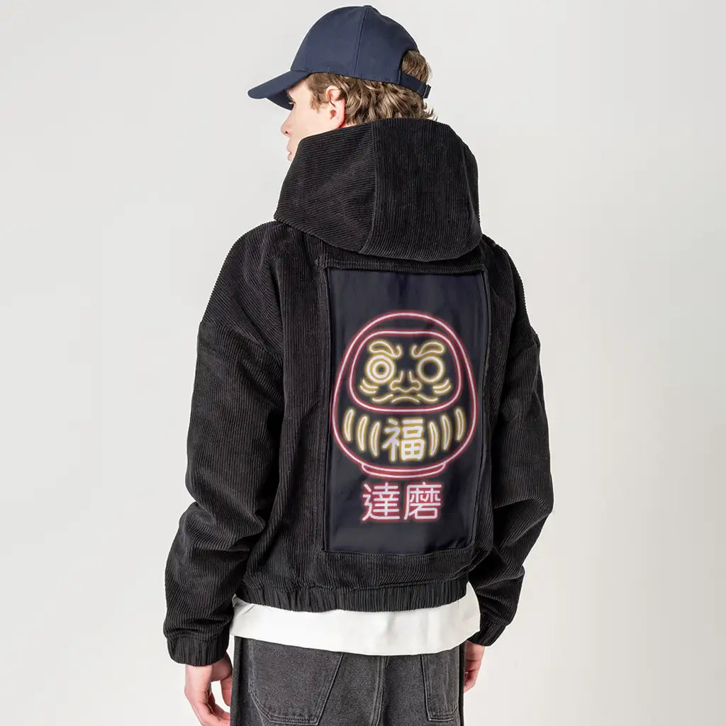 neondaruma patch on male retro cord hoodie in onyx