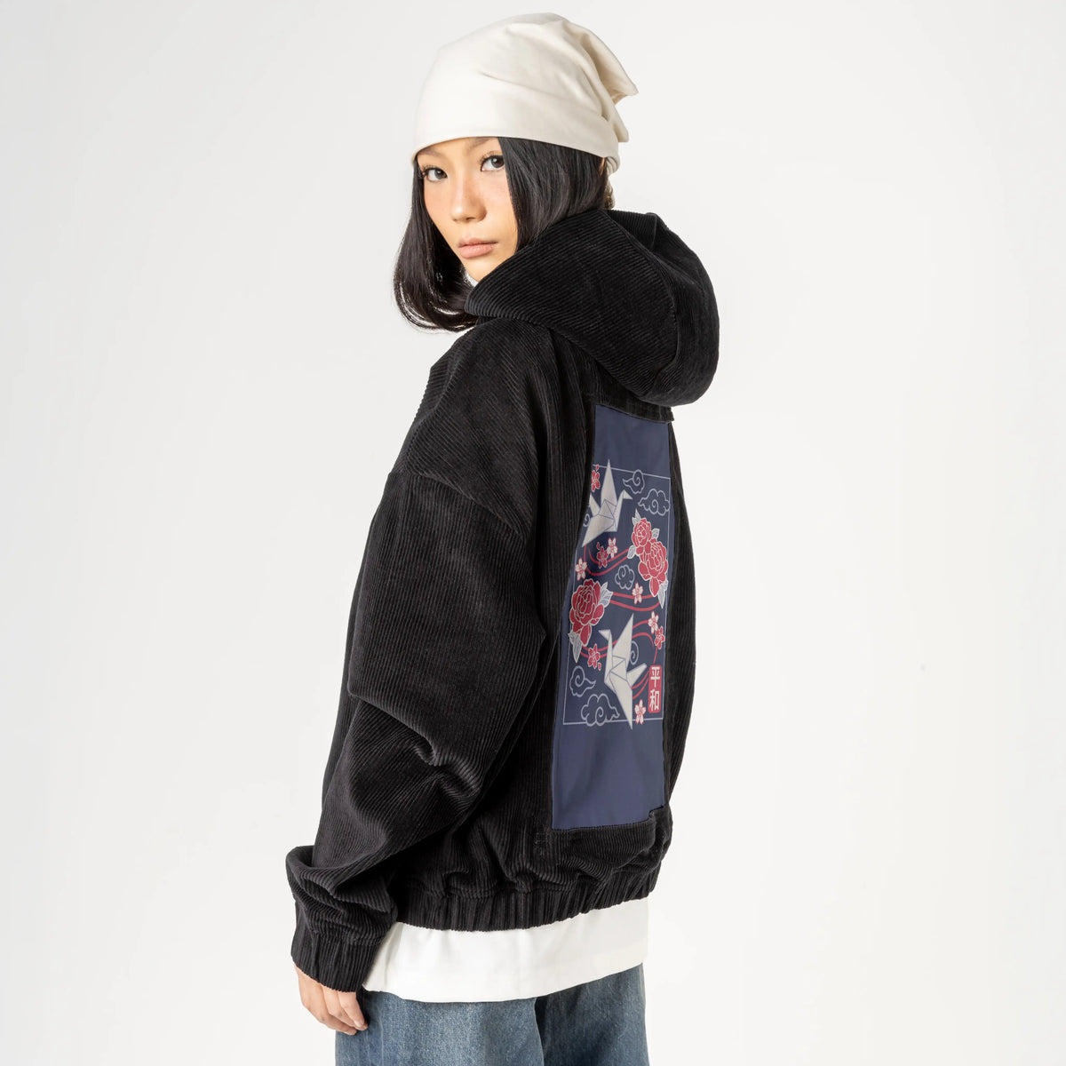 origamicrane patch on female retro cord hoodie in onyx