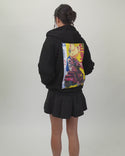 Model wearing the black After Hours Hoodie with swappable art panels, showing front, back, and fit.