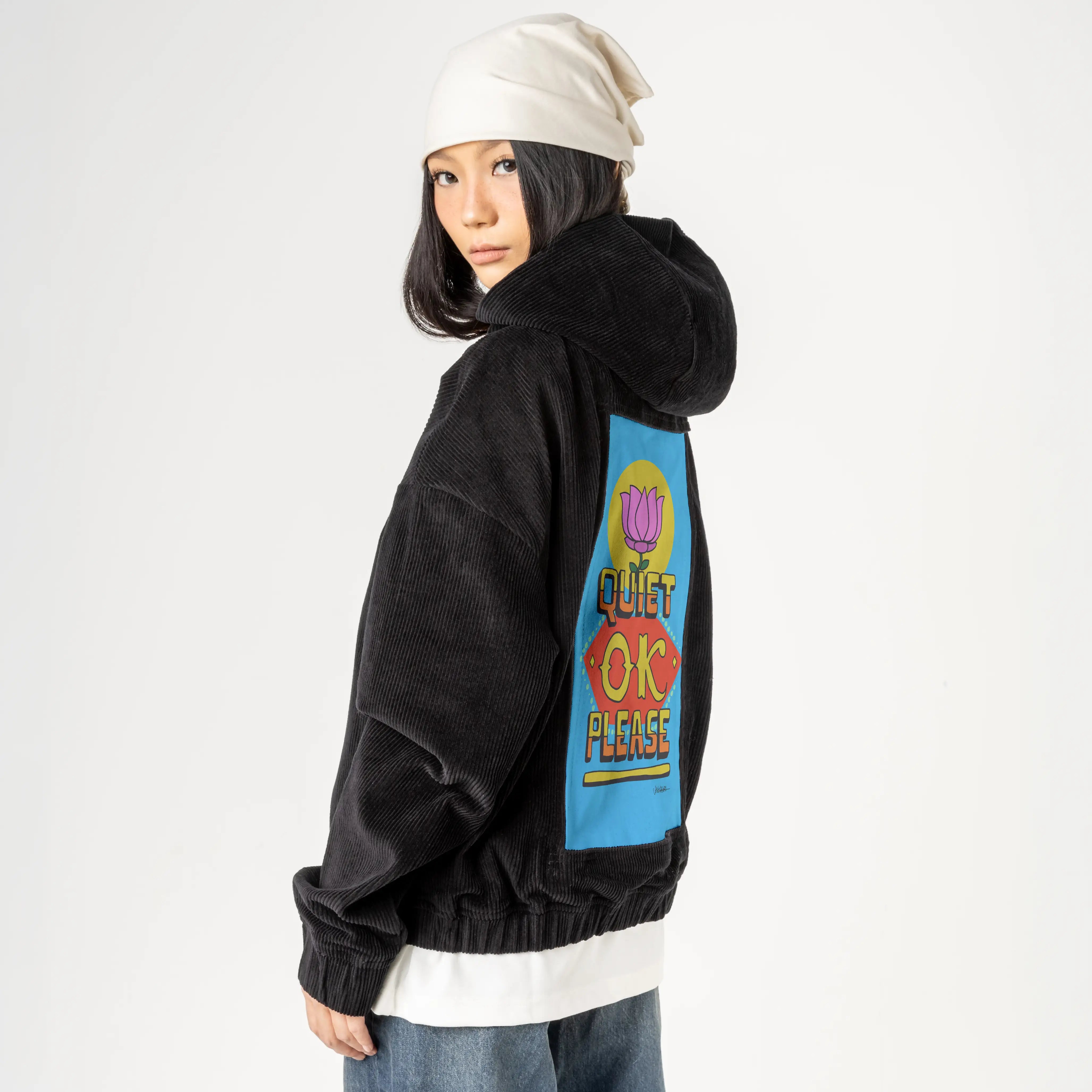 quietokplease patch on female retro cord hoodie in onyx