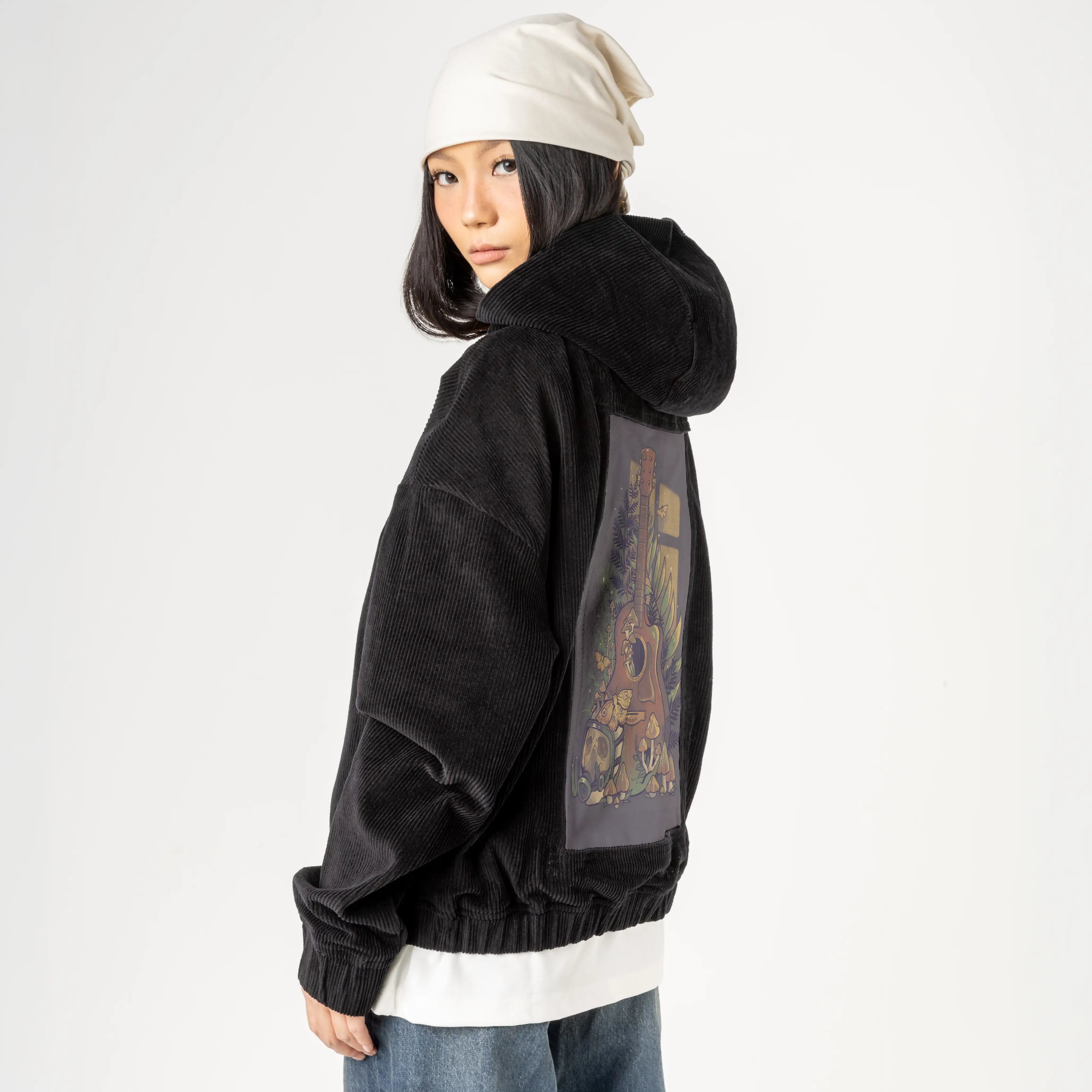 survivalsong patch on female retro cord hoodie in onyx