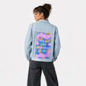 whatthisworldneeds patch on female og denim jacket in oceanside