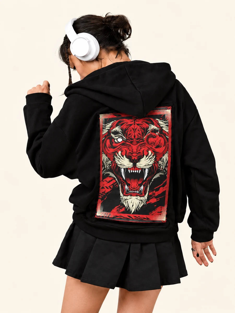After Hours Hoodie with Vermillion Beast art, worn by a woman in headphones dancing with one arm raised.