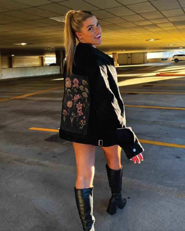 A black OG Denim Jacket styled with Twilight Botanica art and tall boots in warm evening light.